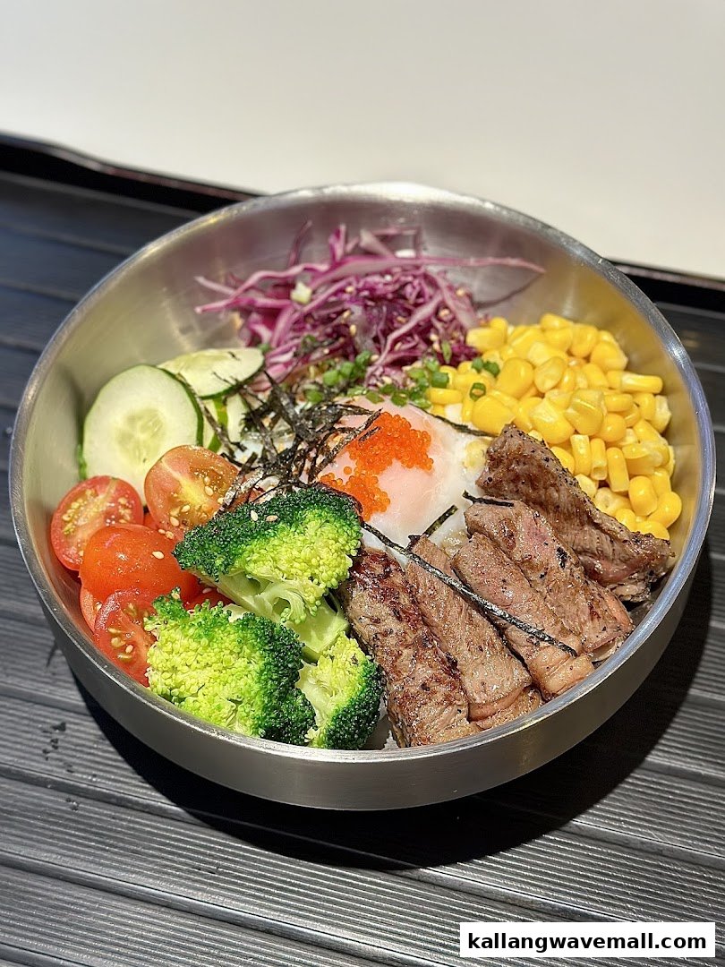 A vibrant bowl featuring grilled meat, fresh vegetables, corn, and a poached egg.