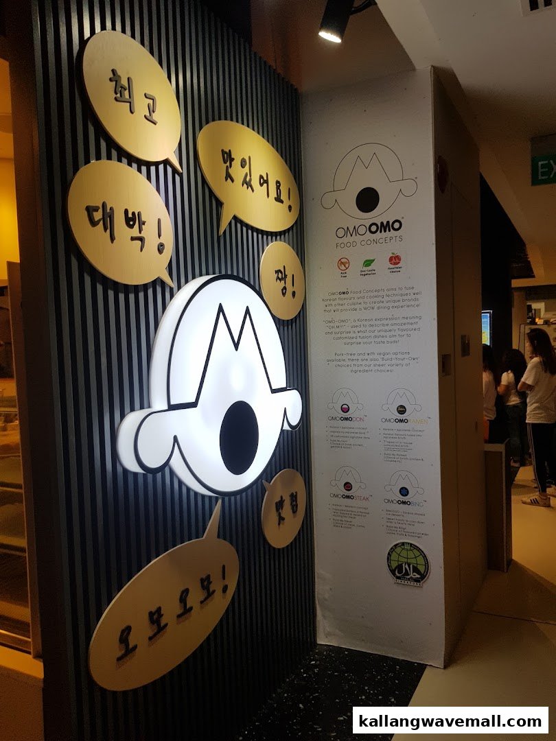 The vibrant entrance of OMOOMO Food Concepts, featuring its unique logo and Korean phrases.