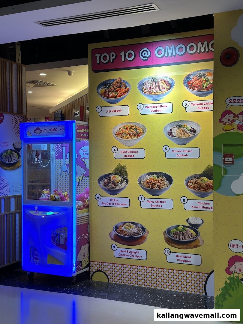 A vibrant display board showcasing OMOOMO's Top 10 dishes, alongside a fun claw machine.