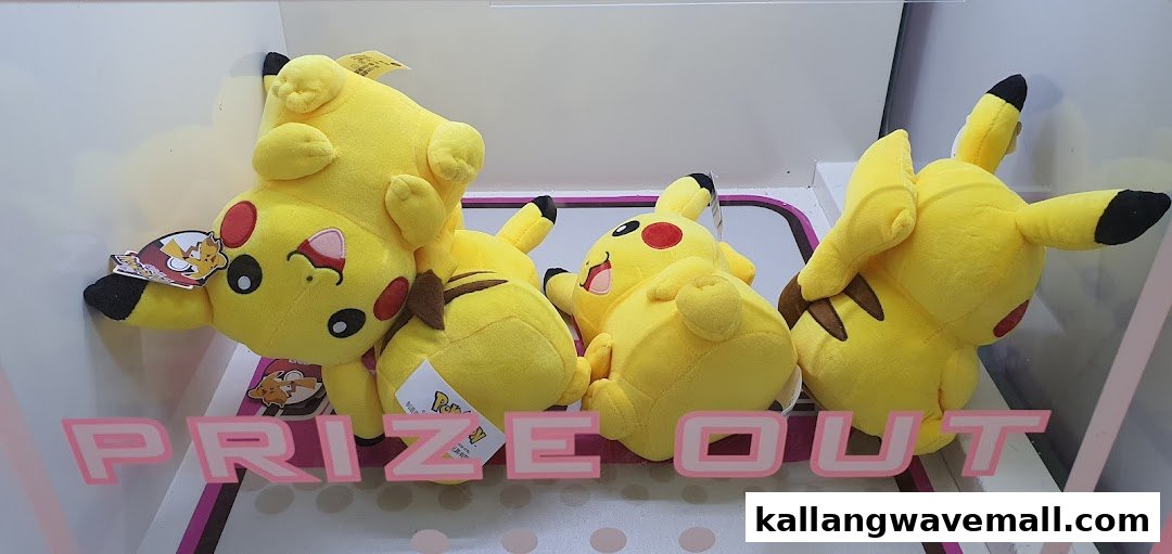 Several yellow Pikachu plush toys are displayed inside a prize machine, with 'PRIZE OUT' visible.