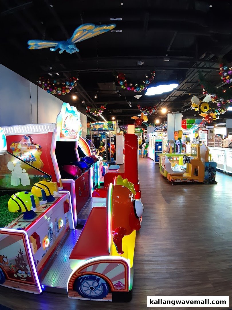 Vibrant interior of an arcade with various colorful games and playful ceiling decorations, inviting family fun.