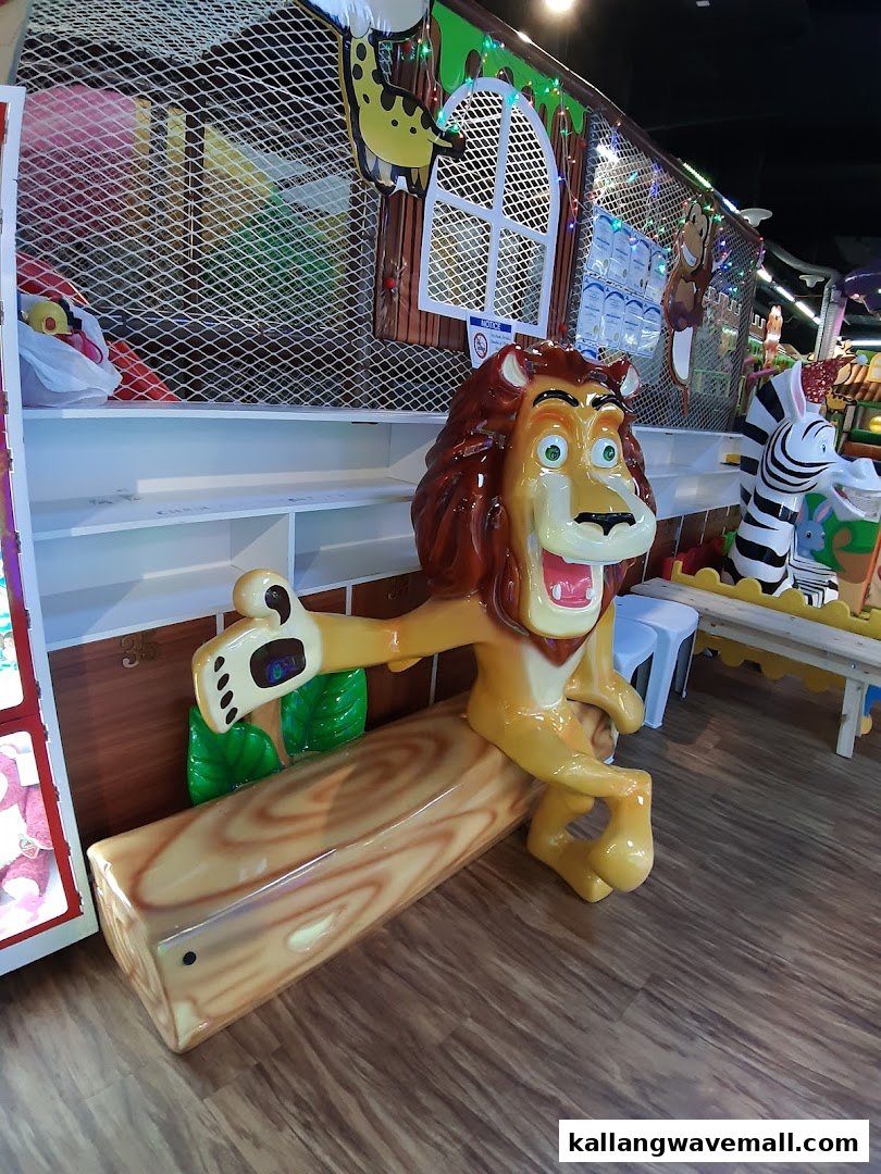 A vibrant indoor play area featuring a large lion character bench and jungle-themed decor.