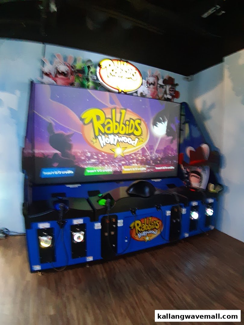 A vibrant Rabbids Hollywood arcade game with multiple player stations inside Paco FunWorld.