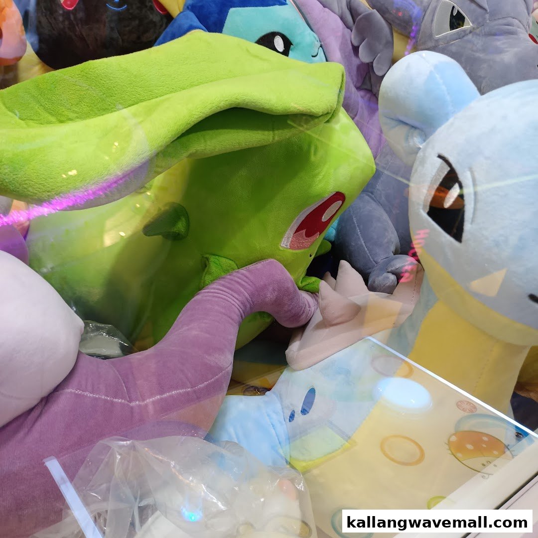 A vibrant collection of Pokémon plush toys inside a claw machine at Paco FunWorld.