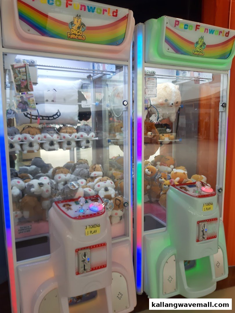 Two brightly lit claw machines filled with plush toys, inviting fun and prizes.