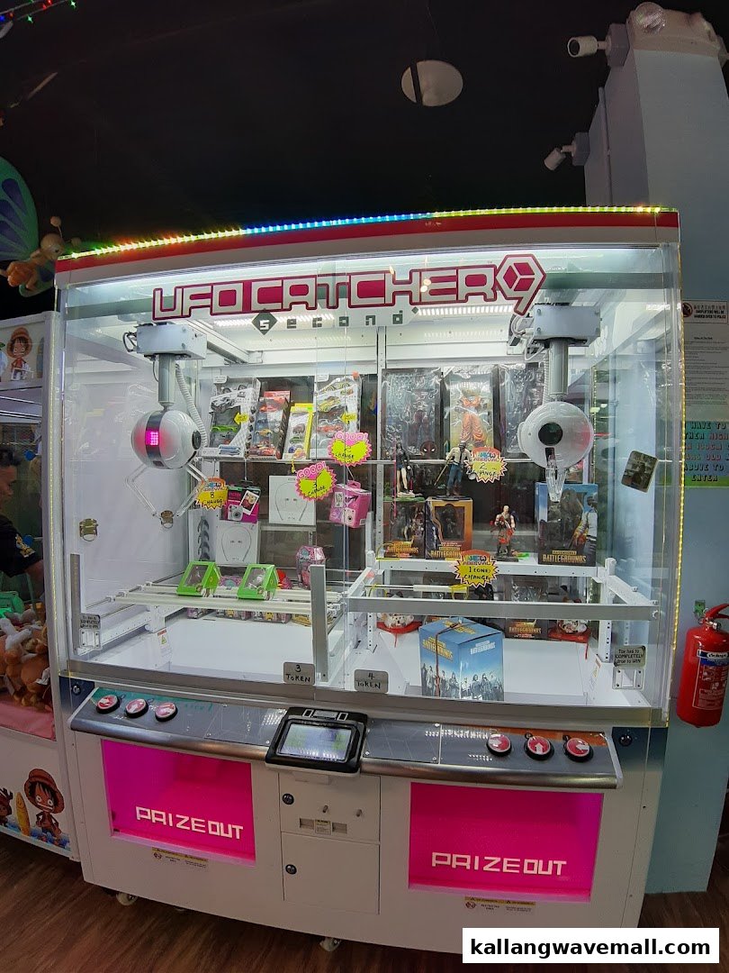A brightly lit 'UFO Catcher' arcade machine at Paco FunWorld, filled with various prizes.