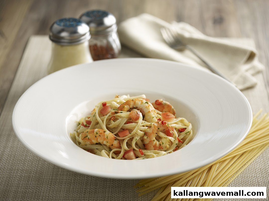 A close-up of a delicious shrimp pasta dish with tomatoes and herbs, ready to be enjoyed.
