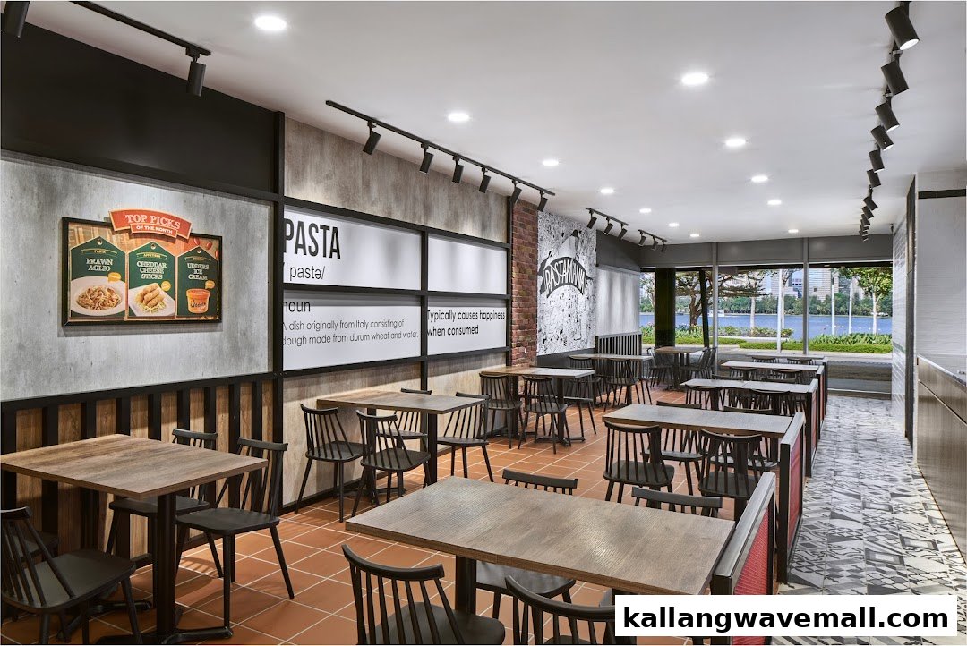 Interior view of PastaMania restaurant featuring dining tables, chairs, and a waterfront view.