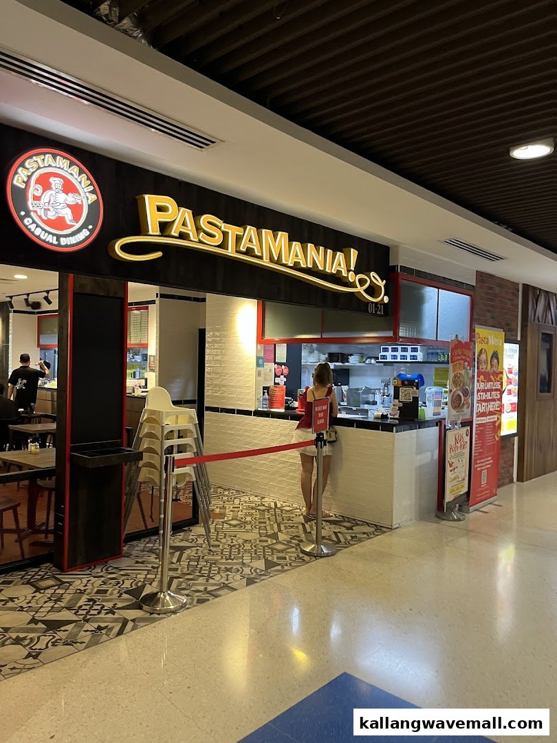 The entrance of PastaMania, an Italian casual dining restaurant, featuring its prominent signage and counter area.