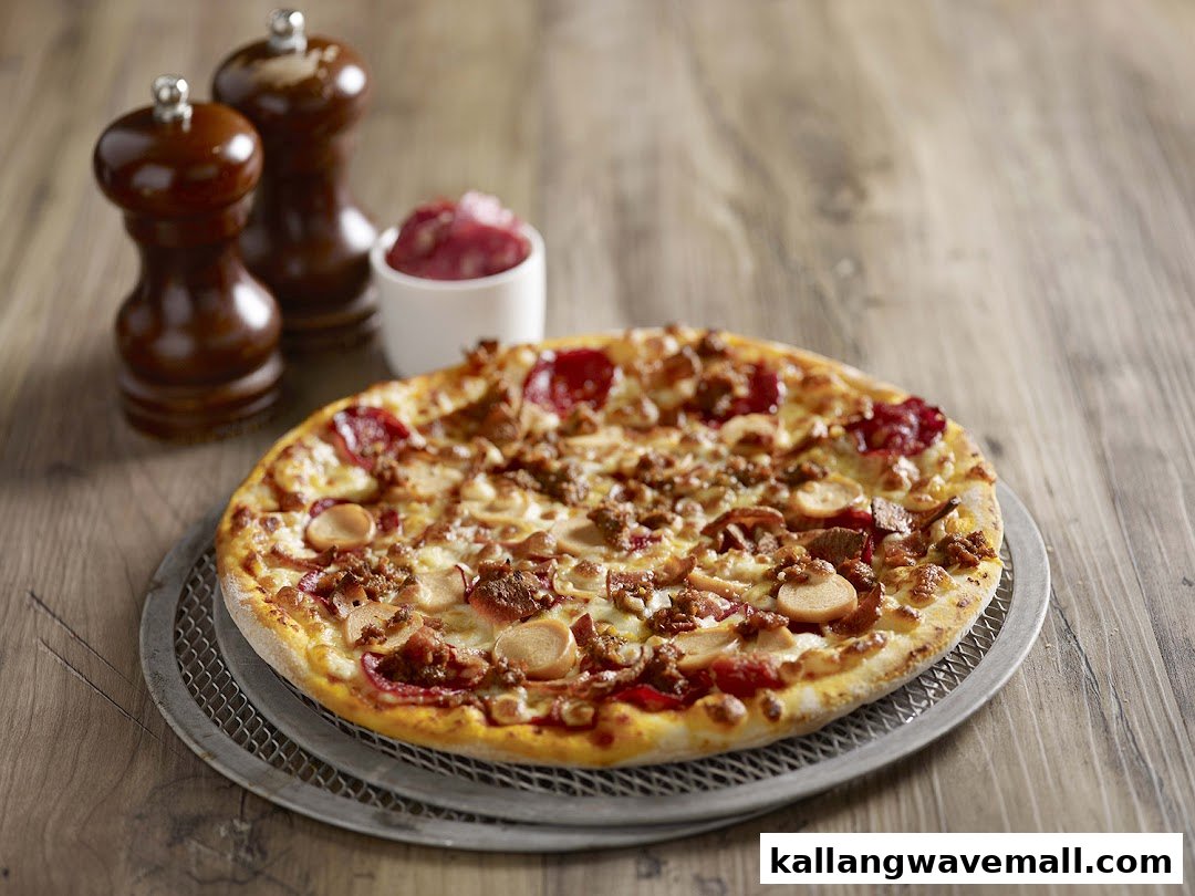 A delicious pizza with various meat and mushroom toppings on a wooden table.
