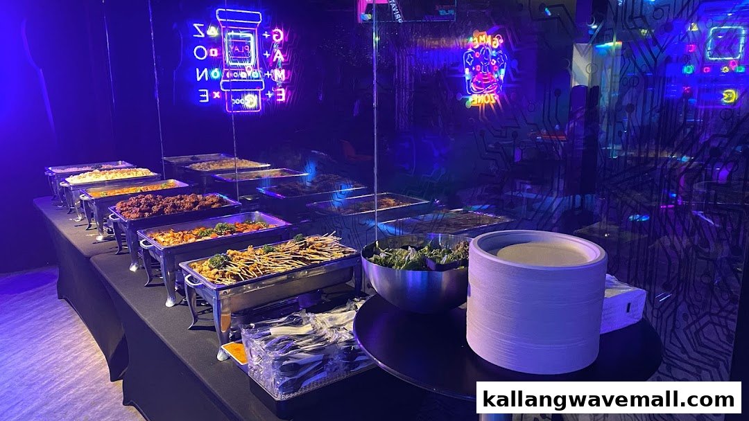 A vibrant buffet spread with various dishes set against a backdrop of neon gaming-themed decor.