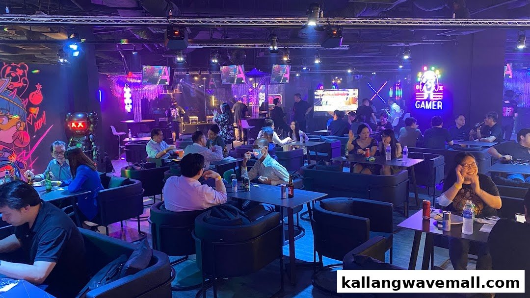 Patrons enjoying drinks and entertainment in a vibrant, neon-lit gaming lounge with large screens.