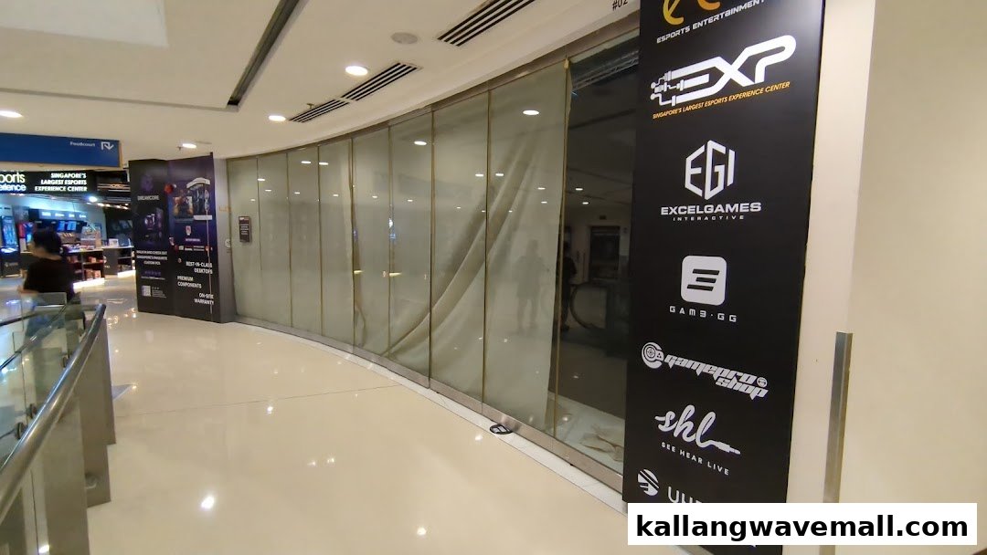 The entrance of PLAYKallang, Singapore's largest esports experience center, featuring promotional banners.