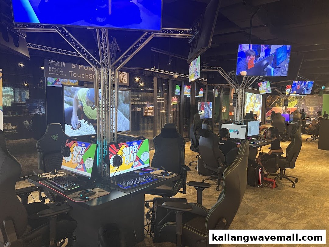 An esports arena with multiple gaming stations, large screens, and people playing video games.