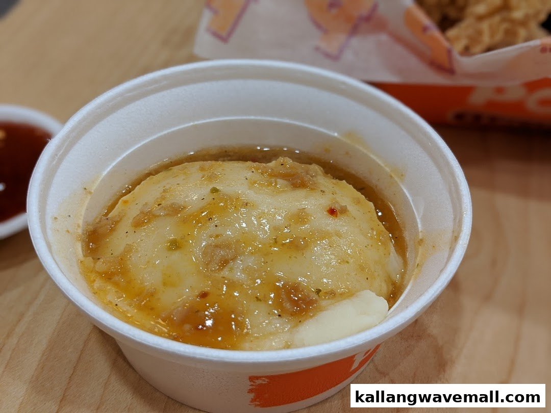 A close-up of Popeyes' creamy mashed potatoes topped with flavorful gravy.