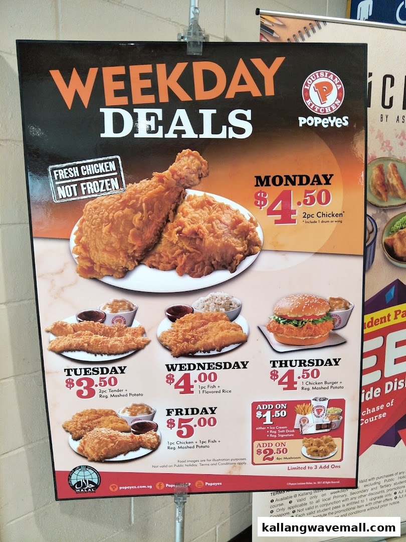 A Popeyes menu board displaying daily weekday deals for various chicken and fish meals.