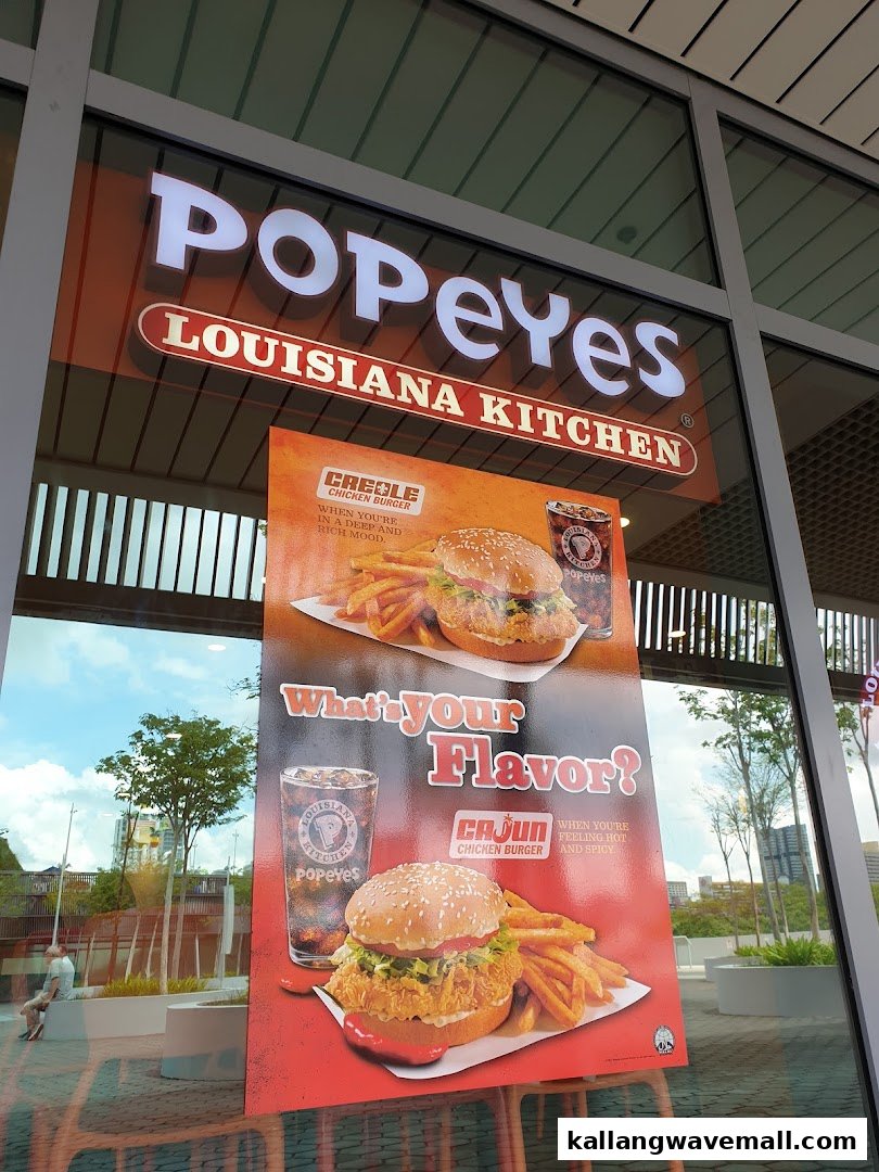 The Popeyes Louisiana Kitchen storefront featuring promotional posters for chicken burgers.