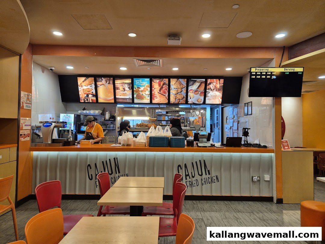 Interior view of Popeyes featuring the service counter, staff, and dining area.