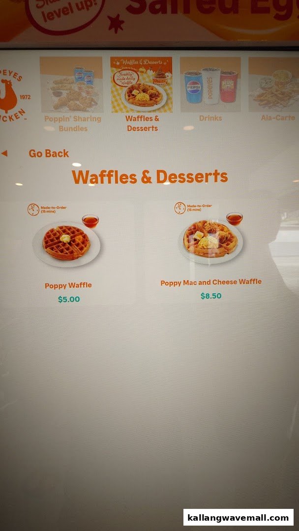 A digital menu screen displaying Popeyes' Waffles & Desserts options with prices.