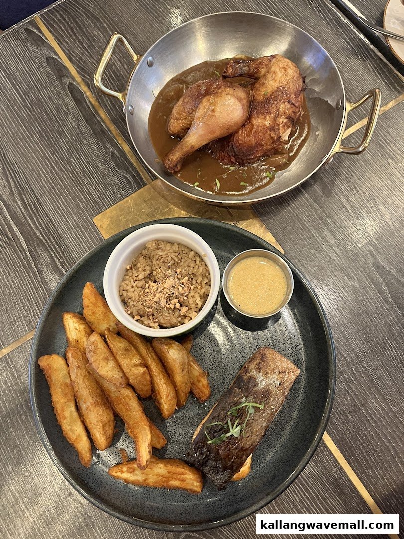 Two delicious dishes from Poulet: a whole roasted chicken in gravy and salmon with crispy potato wedges.