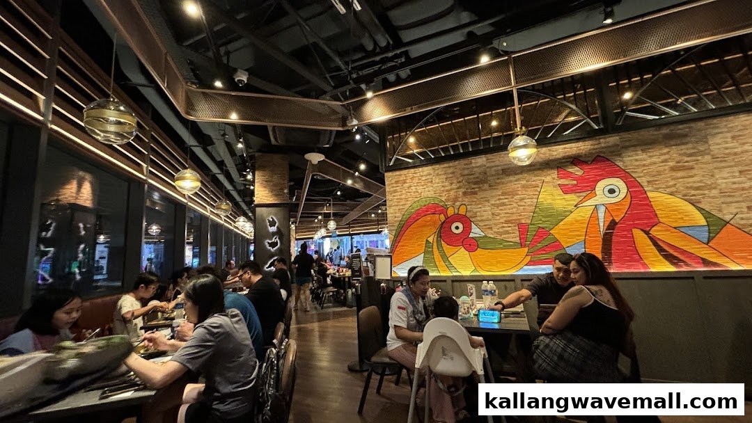 Diners enjoying meals in the vibrant interior of Poulet restaurant, featuring a colorful chicken mural.
