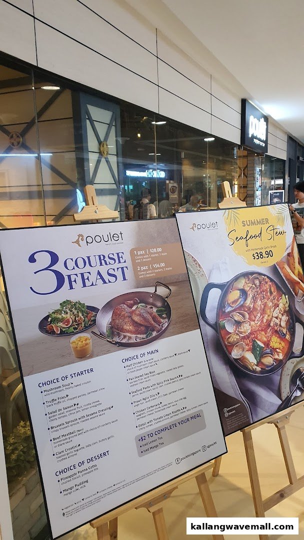 Two large menu boards displaying Poulet's 3-Course Feast and Summer Seafood Stew specials outside the restaurant.