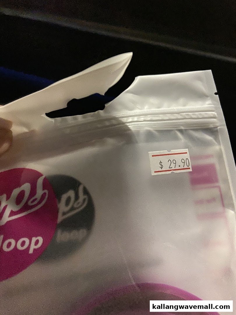 A clear plastic bag containing a product, possibly a tech accessory, with a visible price tag of $29.90.