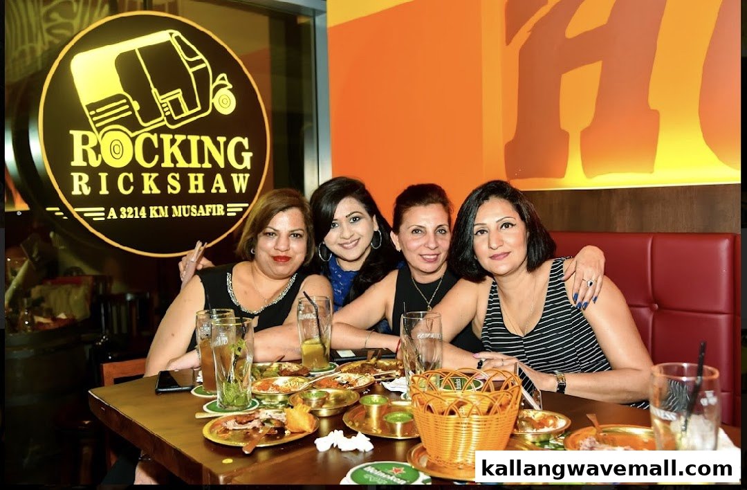 Four women enjoying a meal and drinks at Rocking Rickshaw restaurant.
