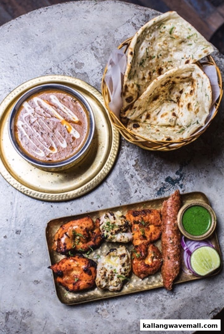 A vibrant spread of Indian dishes including kebabs, dal, and naan bread.