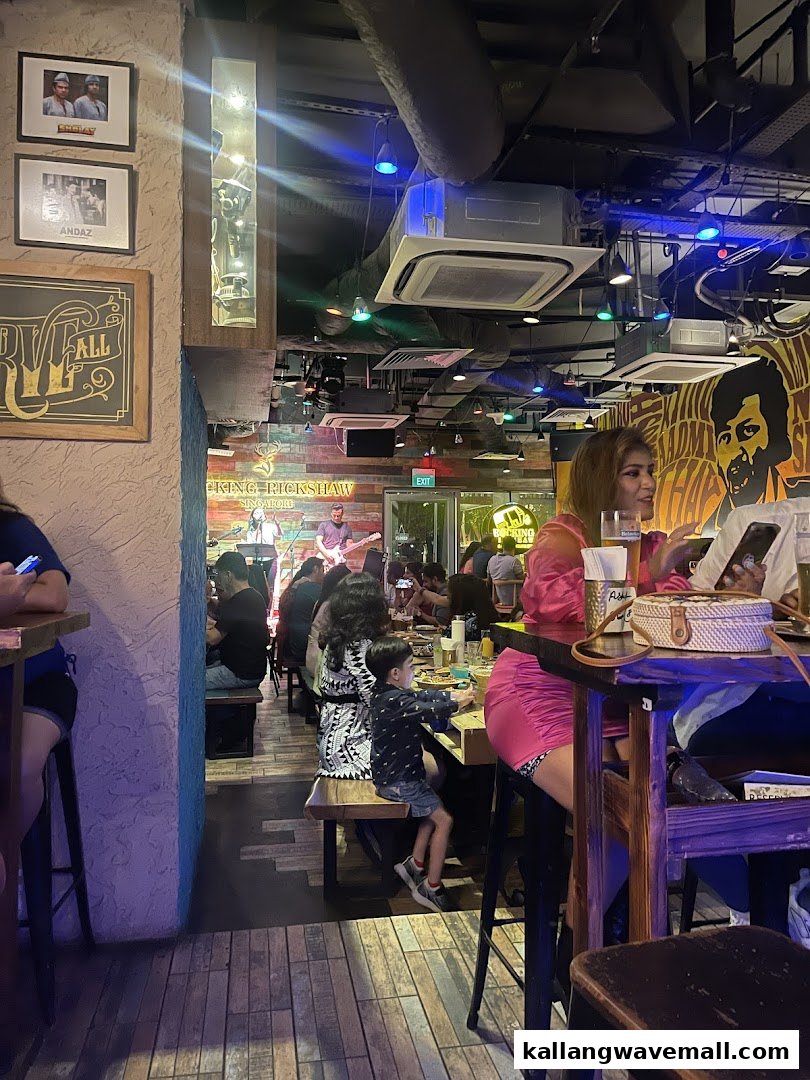 Diners enjoying a lively evening inside Rocking Rickshaw, featuring live music and vibrant decor.