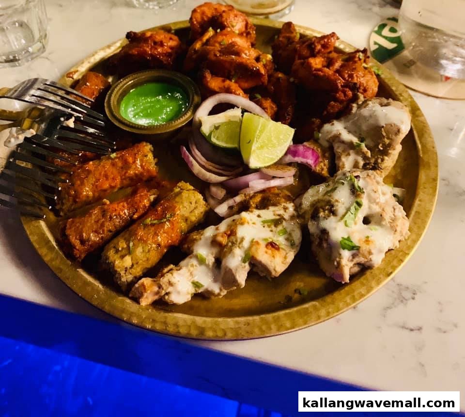 A vibrant platter of assorted Indian appetizers with sauces and garnishes.