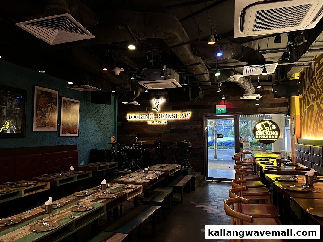 Interior view of Rocking Rickshaw restaurant, featuring dining tables, a stage, and vibrant decor.
