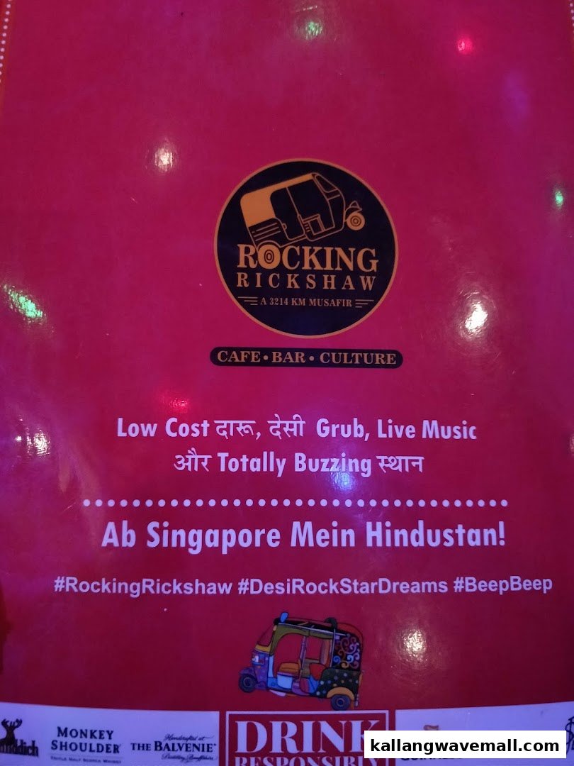 A vibrant red promotional sign for Rocking Rickshaw, highlighting its cafe, bar, and culture offerings.