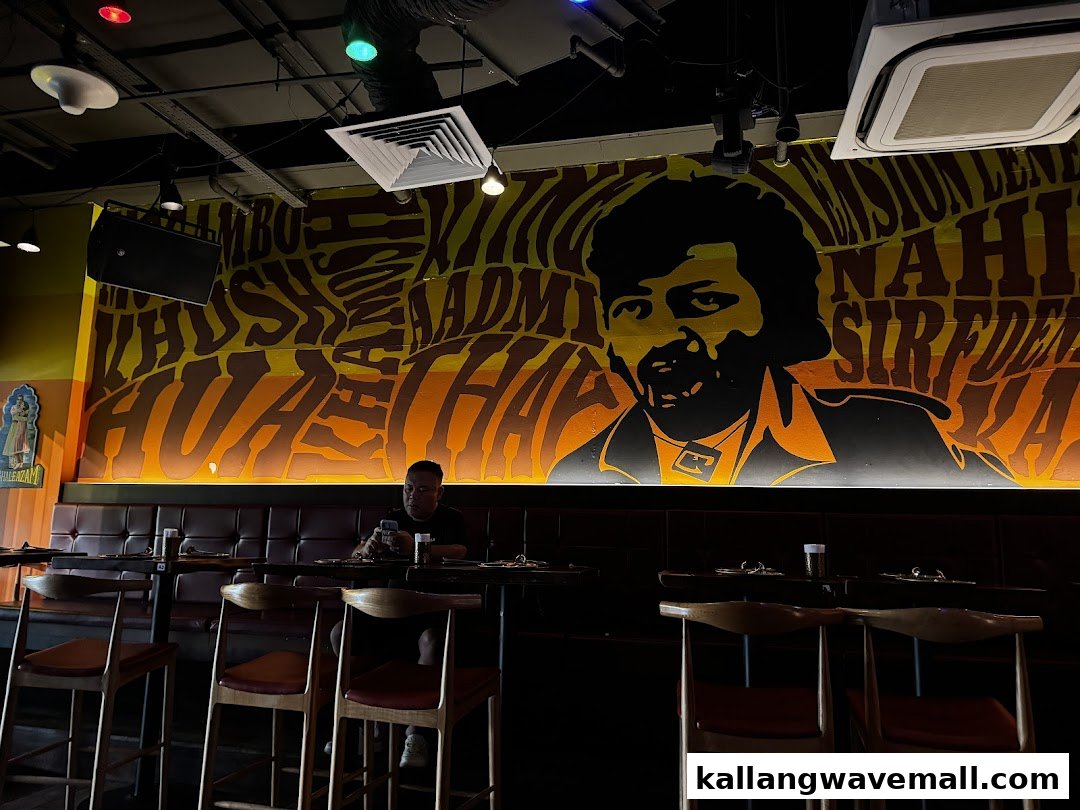 Interior view of Rocking Rickshaw featuring a vibrant mural and a customer seated at a table.
