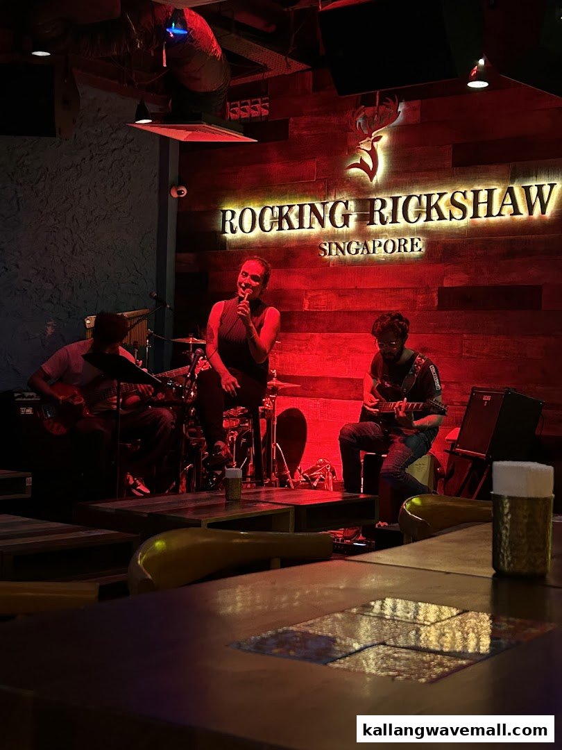 A band performs live music under red lighting at Rocking Rickshaw, Singapore.