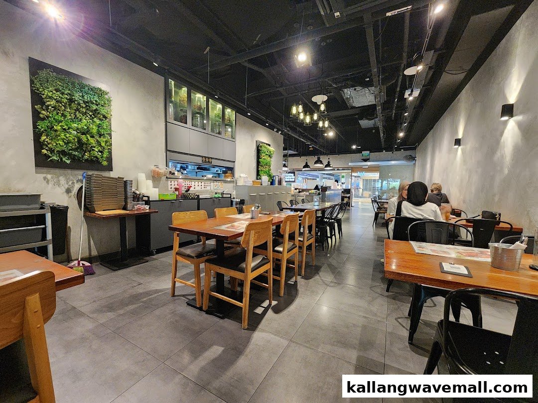 Interior view of Sanook Kitchen, featuring dining tables, a kitchen counter, and customers enjoying their meal.