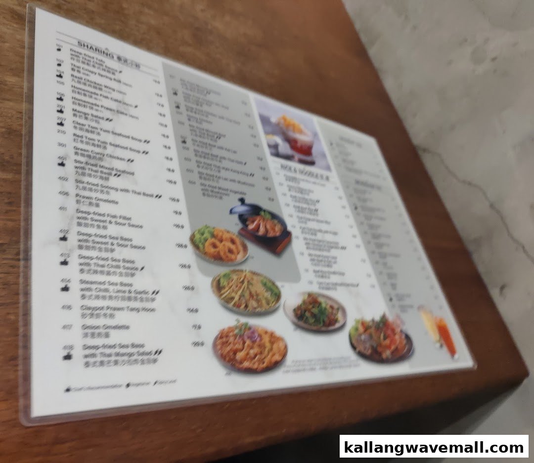 A close-up view of a Thai restaurant's menu displaying various sharing dishes and main courses.