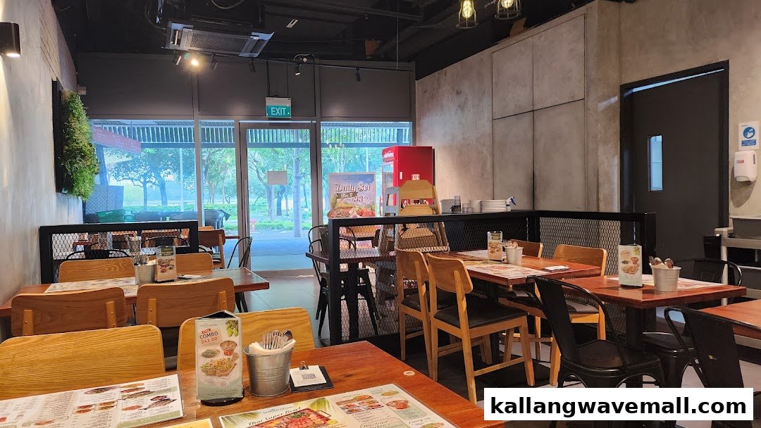 An inviting interior view of Sanook Kitchen, featuring wooden tables, modern chairs, and a bright outdoor view.
