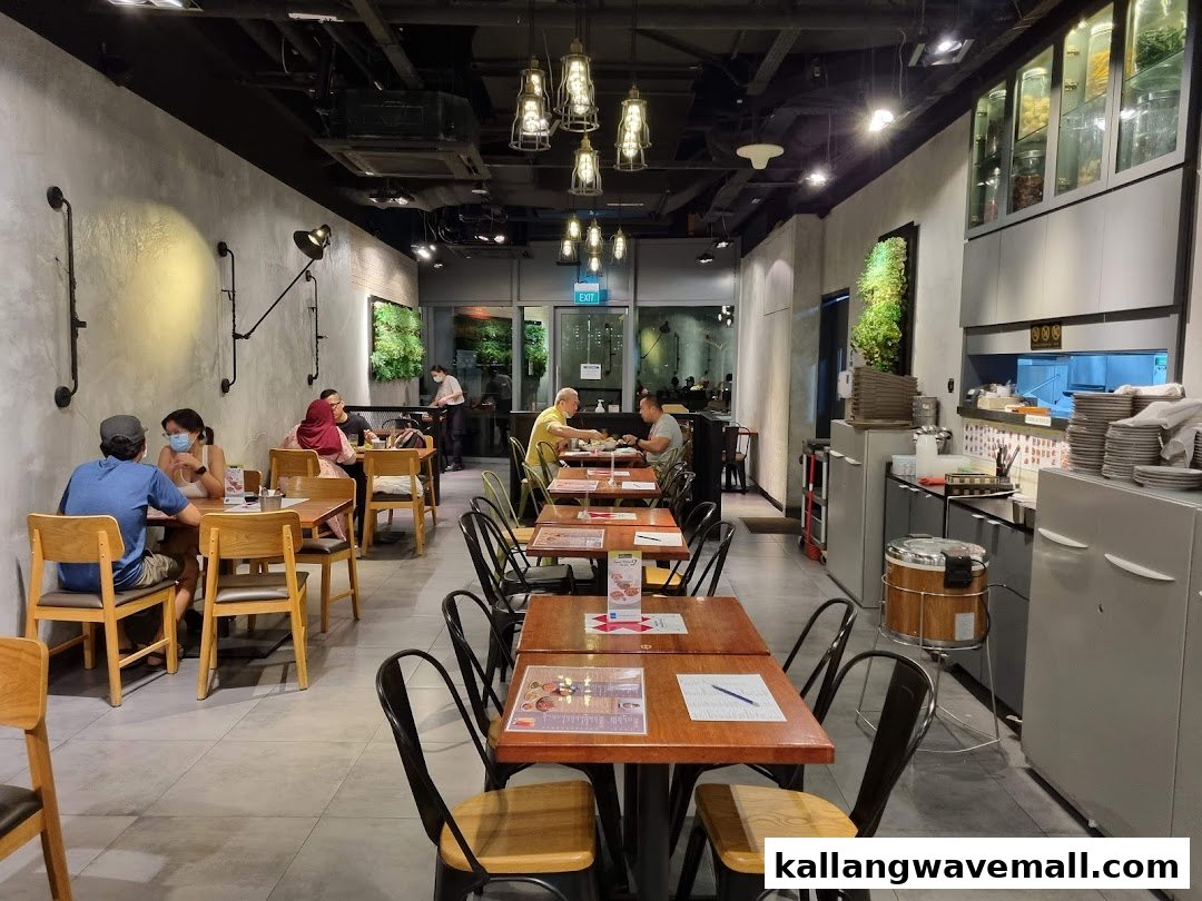 Interior view of Sanook Kitchen, showing customers dining in a modern, industrial-chic restaurant setting.