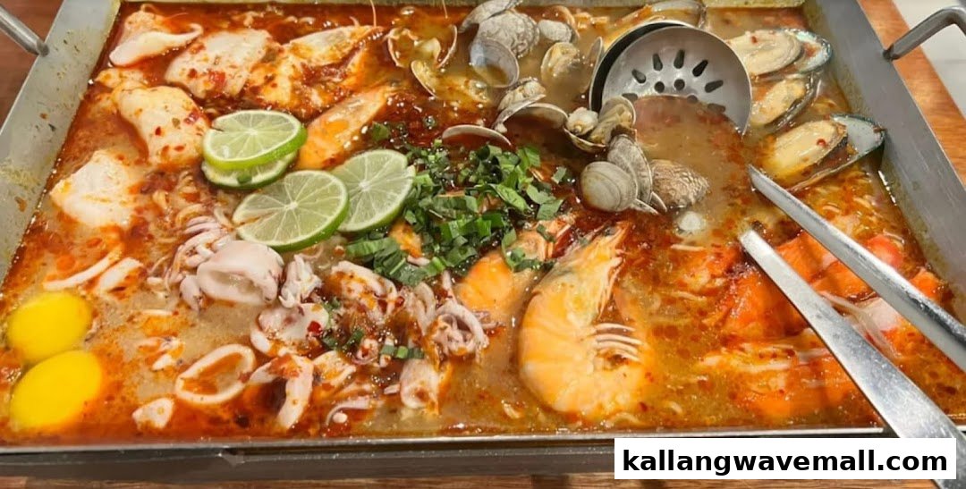 A vibrant, large platter of spicy Thai seafood hotpot with prawns, squid, clams, mussels, and fish.
