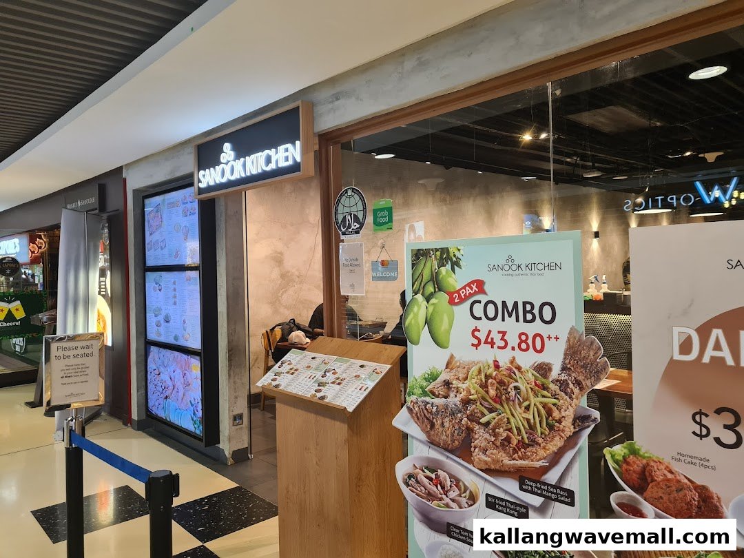 The vibrant entrance of Sanook Kitchen, a Thai restaurant, featuring promotional displays and signage.