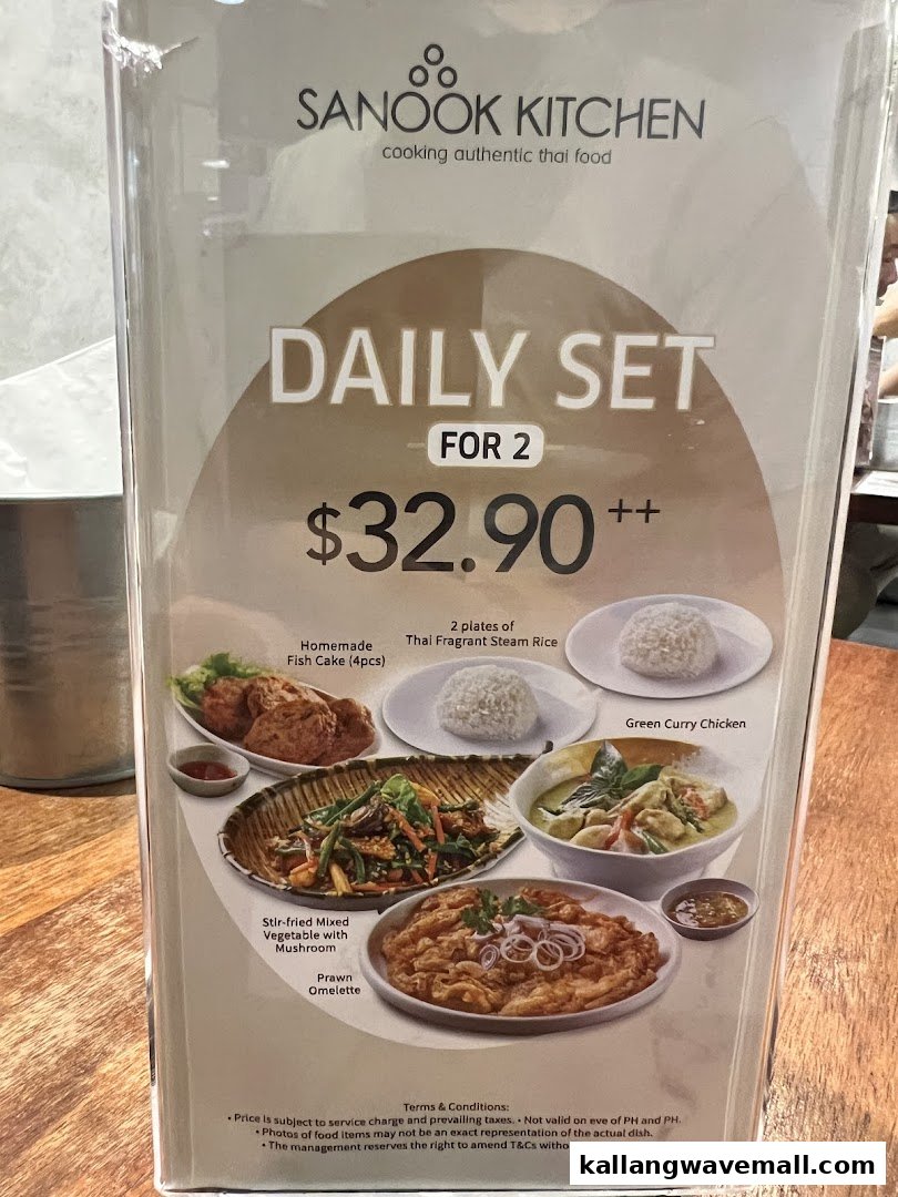 A menu board displaying Sanook Kitchen's 'Daily Set for 2' with various Thai dishes.
