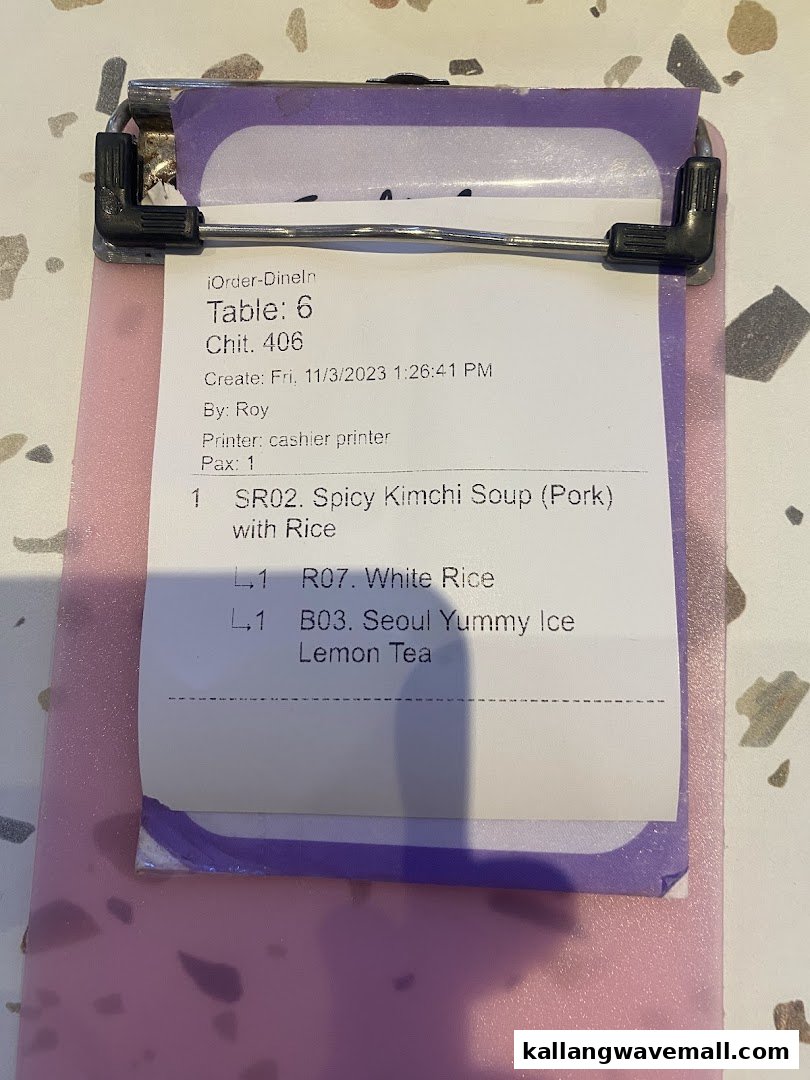 A close-up of a digital order slip for a Korean meal, including kimchi soup and rice.