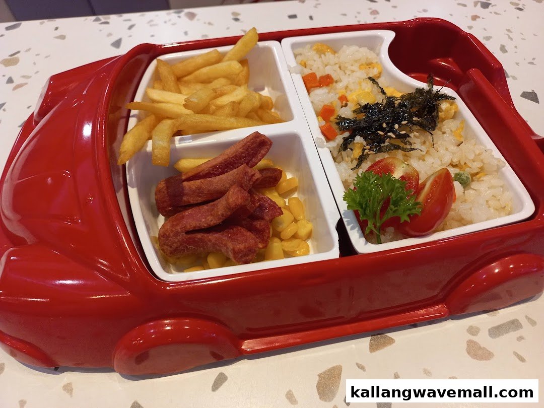 A fun kids' meal served in a red car-shaped plate with fries, sausages, and fried rice.