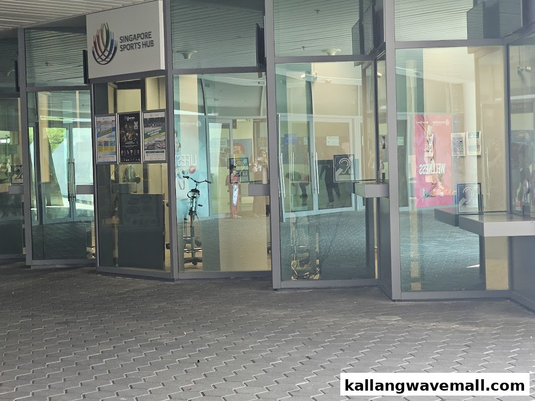 Exterior view of the Singapore Sports Hub Box Office, featuring glass doors and promotional posters.