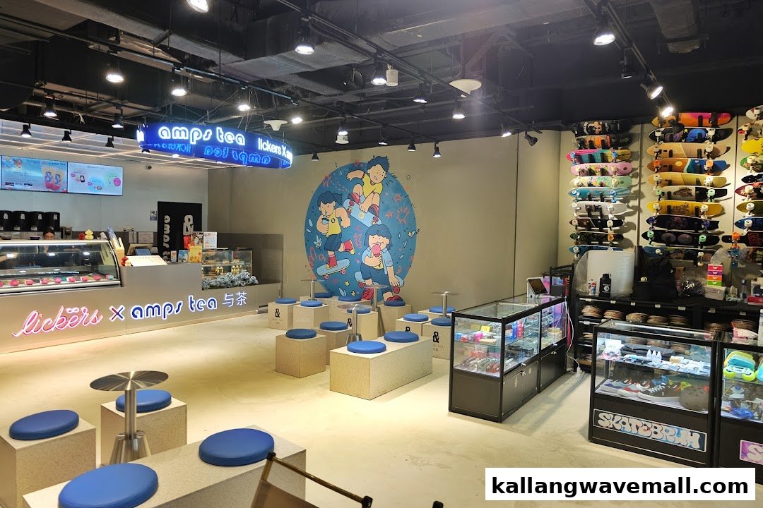 An interior view of a vibrant shop featuring a dessert and tea counter, a colorful mural, and a large display of skateboards.