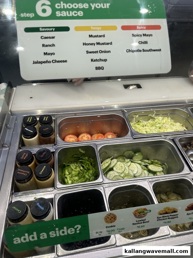 A close-up of Subway's fresh ingredients, sauce selection, and side menu options.