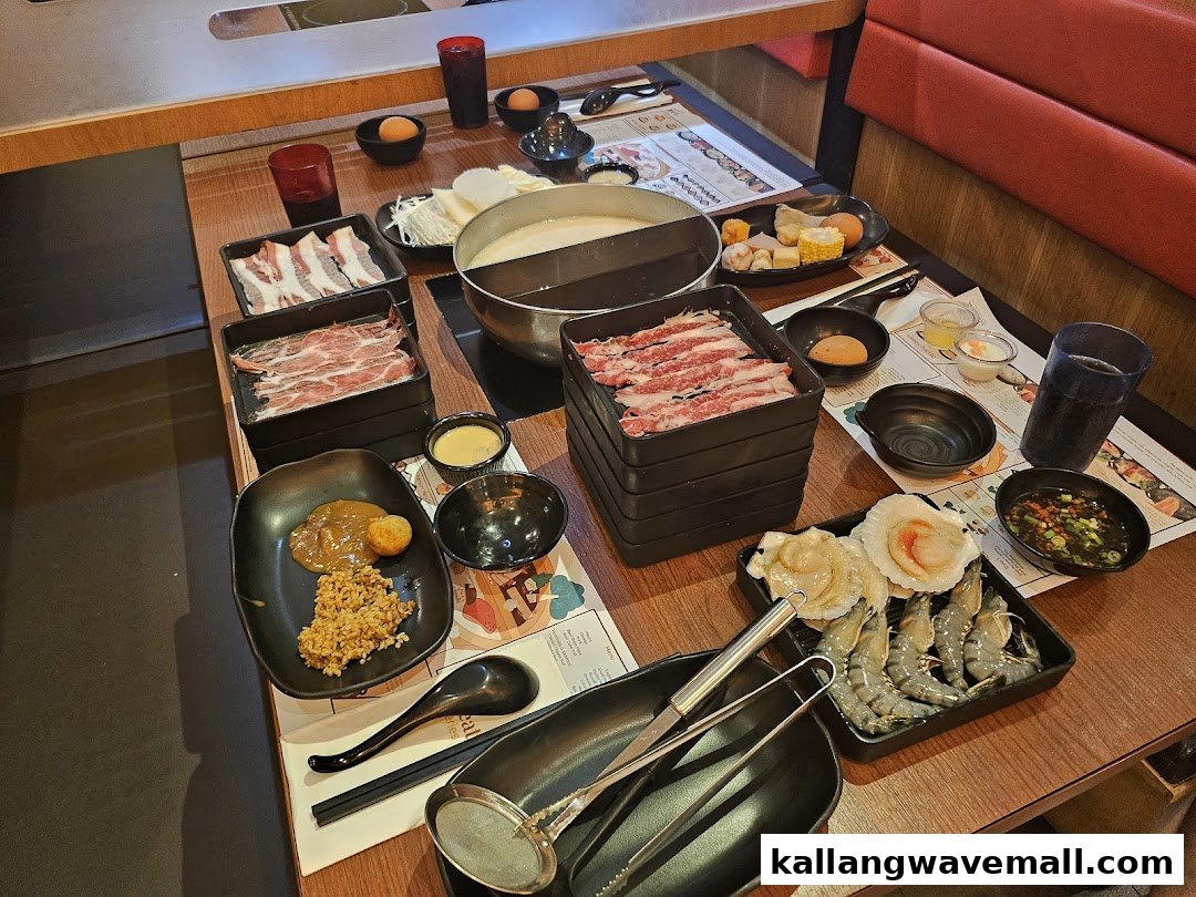 A table laden with fresh ingredients for an all-you-can-eat shabu-shabu meal at Suki-Ya.
