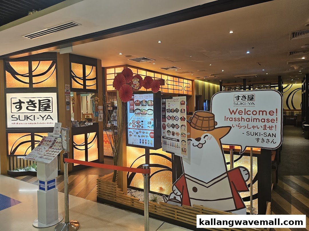 The inviting entrance of Suki-Ya, an all-you-can-eat sukiyaki and shabu-shabu restaurant, featuring a welcoming mascot.