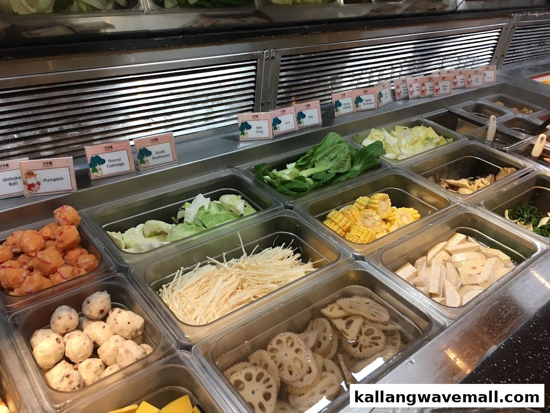 A vibrant selection of fresh ingredients, including vegetables, mushrooms, and various balls, for an all-you-can-eat shabu-shabu experience.